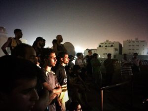 Audience on a rooftop in Dammam, Saudi Arabia, for a piece of immersive theatre